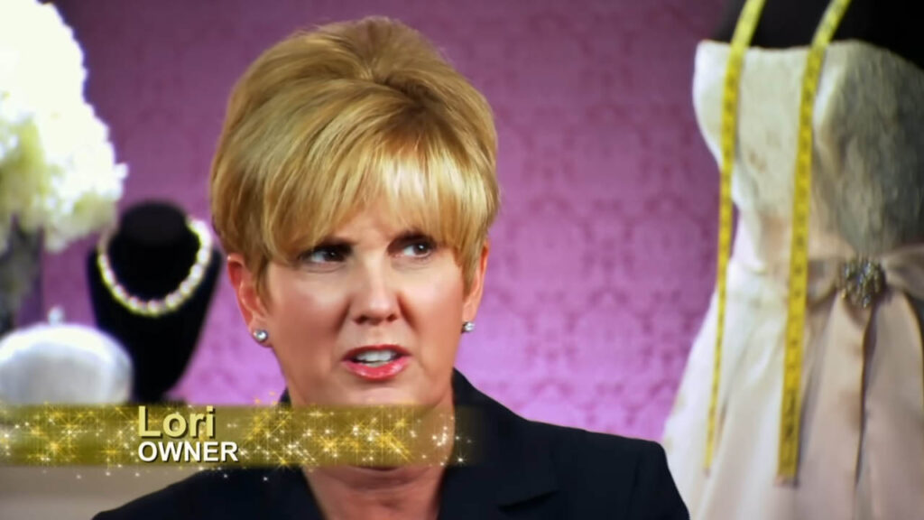 Bridal consultant looking shocked after hearing the bride has tried on 50 wedding dresses.