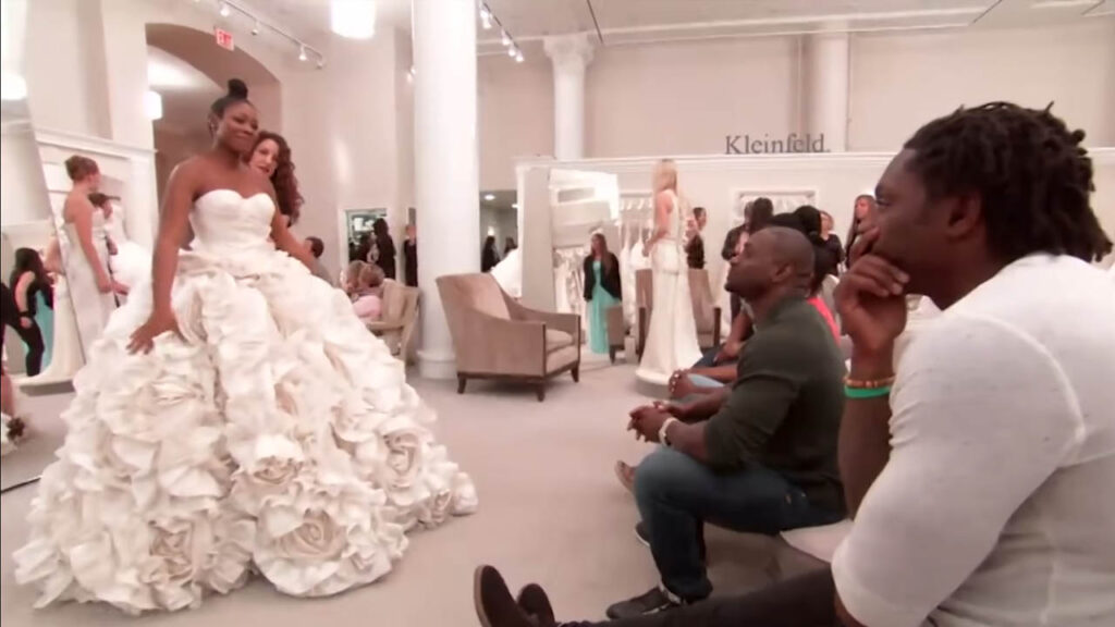 Exhausted bride struggling to walk in a heavy $29,100 Pnina Tornai wedding dress.