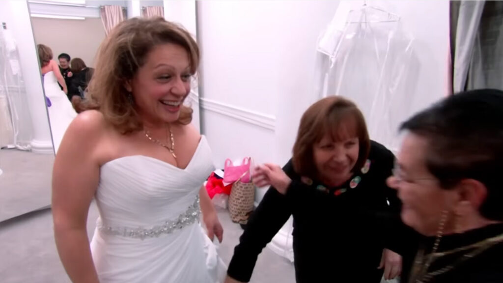 Mature bride looks young, tall, and skinny in her custom fitted wedding dress.