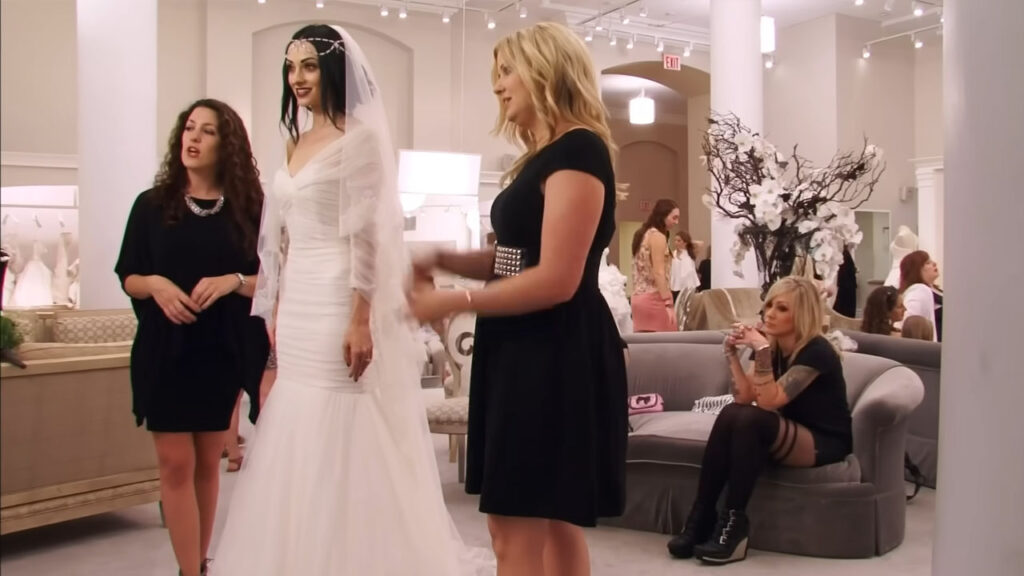Edgy bride loving her Monique Lhuillier wedding gown fitting.