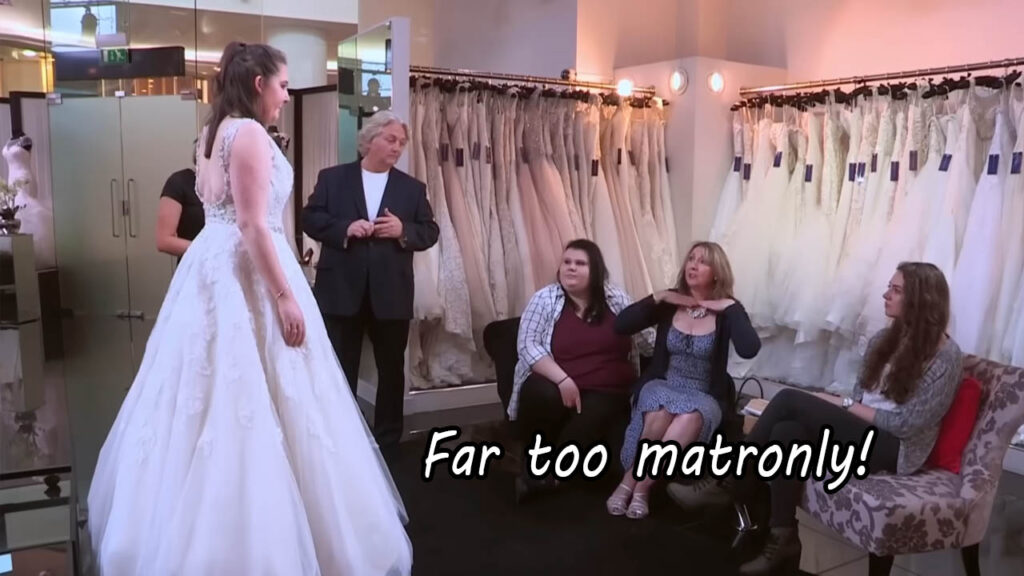 Family members brutally critiquing a terrible wedding dress choice during fitting.