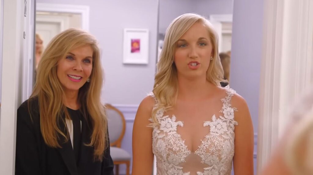 Attention seeking mother wearing a sheer wedding dress trying to steal the spotlight from the bride.