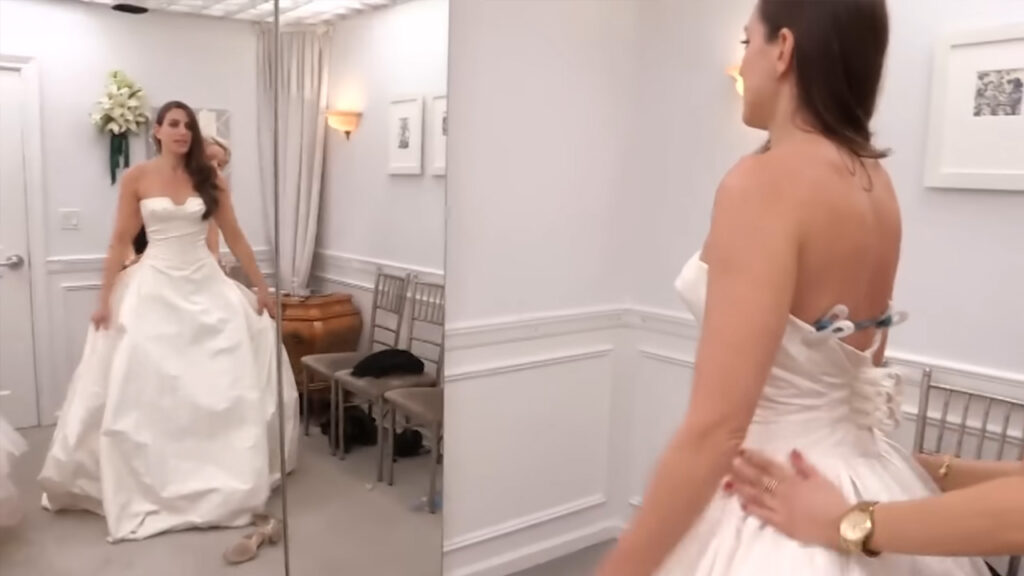 Picky bride scrutinizes the fabric of a designer wedding dress at Kleinfeld