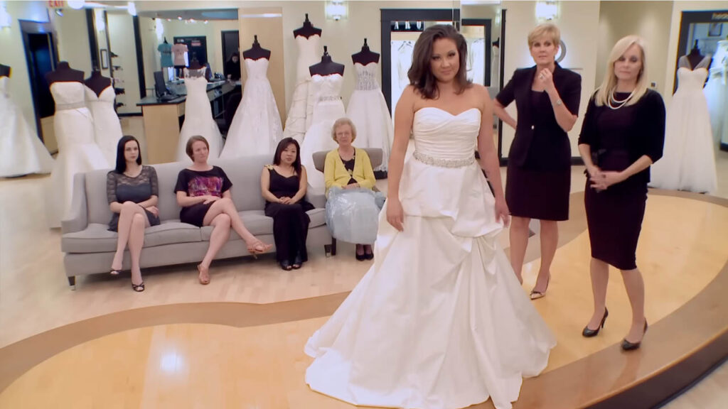 Bride trying on traditional ball gown wedding dresses for a courthouse ceremony.