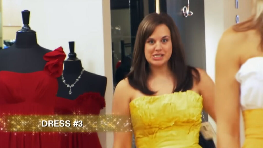 Bridesmaid Stacy wears a yellow dress that the bride compared to a cheese nacho