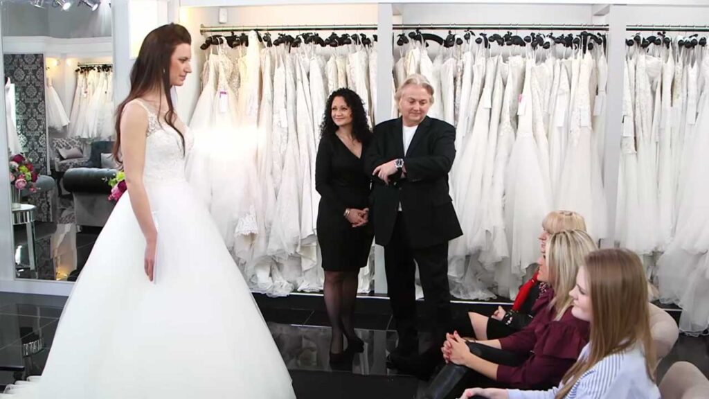 Tomboy bride feeling unhappy and uncomfortable in a massive princess ballgown forced by her mother.